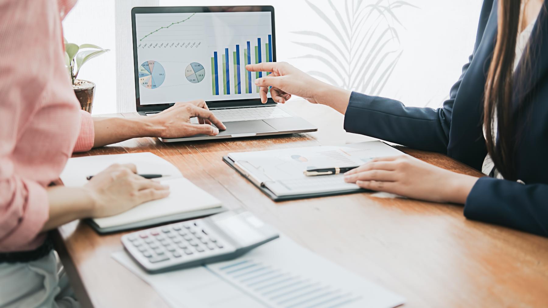 TBA & Associates accountant reviewing financial statements with a small business owner